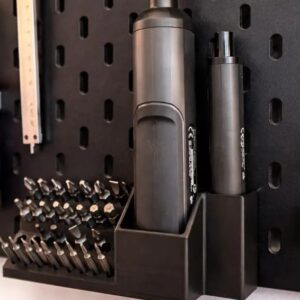 Detalhe lateral de um suporte impresso em 3D no painel Skadis, destacando as pontas hexagonais (bits) organizadas num formato de escadaria.